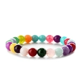 Macro detail of multicolored round agate beads on a flexible beaded strand bracelet - Colorful Stone