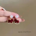 Detailed macro view of rocking horse earring featuring red flocking and white pearl - Red Flocked Rocking Horse Pearl Studs (1#银针-金色-红色(真金电镀))