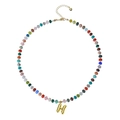 Detail of bohemian colorful beaded necklace featuring a golden bubble letter H pendant - Letter H