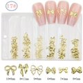 Detail view of 6 styles of gold alloy bow nail charms in a partitioned storage bag - GZMD-17 Gold Bowknots