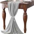 Elegant grey chiffon table runner tied with white ribbon on a wooden dining table - Gray