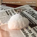 White heart-shaped scented candle with intricate rose relief on vintage newspaper background - White