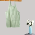 Minimalist light green cotton linen apron hanging on wood hook with front pocket detail - Kids Mint Green