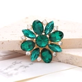 Detailed macro view of green horse-eye crystal flower accessory with gold alloy base - Green