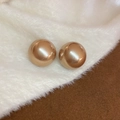 Close-up of polished gold sphere earrings on white plush fabric for a luxury look - 69# Gold Round Pearl