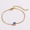Detail of adjustable gold chain bracelet featuring a blue round gemstone in four-prong setting - Blue Zirconia (Round Blue)