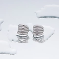 Minimalist silver pleated hoop earrings with bold rib texture on a mirrored surface - Wave Round Style 3 - Steel