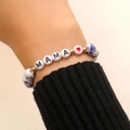 Detail of beaded MAMA bracelet with floral ceramic beads and red heart on wrist - MAMA Letter Heart Style (A-1090)