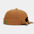 Detail of caramel canvas docker cap featuring green shamrock embroidery and metal buckle - Adjustable / Caramel color