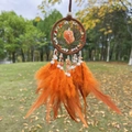 Detail of dream catcher with orange feathers and natural stones against a blurred background - Red Agate Brown Hoop