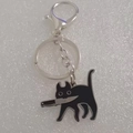 Funny black cat keychain holding a knife made of durable titanium steel with enamel finish - Keychain (Lobster Clasp)