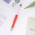 Vibrant orange beadable DIY creative pen with metallic rod on a minimalist desktop - Orange