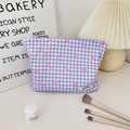 Detail of purple plaid makeup bag with pink bow decoration on a vanity desk - Purple Plaid Bow