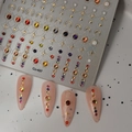 Close-up of celestial gold foil nail stickers with moon, stars and crystal rhinestones - Gold Foil Moon Star Sun Rhinestone Style (CO-497)