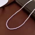 Macro shot of high-luster lavender pearl necklace on dark leather and white ceramic tray - 4mm / Purple