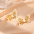 Elegant gold hollow butterfly earrings with white pearl detail on champagne satin fabric - Pearl Butterfly