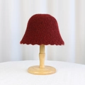 Elegant deep red knitted bucket hat with plush texture on a wooden display stand - Crochet Hollow Wavy Brim (8980) / Burgundy