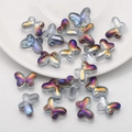 Macro shot of 10x14mm aurora butterfly glass beads with rainbow gradient for DIY jewelry - Semi-transparent Purple