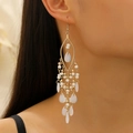 Detail of bohemian long tassel earrings with golden plating and white beads on model - KC Gold S552