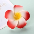 Macro shot of realistic red and white gradient EVA plumeria flower with yellow center - Red