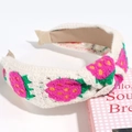 Close-up of beige knitted headband featuring pink strawberry embroidery and soft texture - Green Stem Rose Red Strawberry Knotted