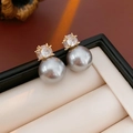 Detail of elegant gold earrings with grey faux pearl and sparkling zircon stone - Silver Needle - Silver Grey Zircon Pearl Studs