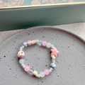 Detail of cute macaron color ceramic beads and cream cake charms on a bracelet - Star - Pink