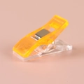 Orange plastic sewing clip with metal spring for fabric positioning and DIY crafts - Orange