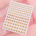 Self-adhesive gold metal rivet stickers on white backing for eye makeup and nail art - Gold Lip Studs