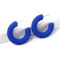 Matte klein blue C-shaped hoop earrings with minimalist aesthetic on white display - Sapphire Blue