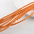 Macro view of oval orange synthetic turquoise beads for DIY jewelry on ceramic plate - 4*6mm (Approx. 60pcs) / Orange