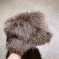 Close-up of thick faux fur material and soft plush texture on the winter bucket hat - Coffee