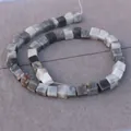 Macro view of square natural stone beads with marble texture for DIY jewelry making - Hawk Eye Stone