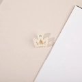 Close-up of a small crown-shaped hair claw clip adorned with creamy white faux pearls - Crown