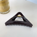 Detailed top view of a dark coffee triangular hair claw clip with a glossy finish - Chocolate