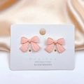 Detail of pink bow-shaped S925 silver needle earrings on display card with satin background - Pink Bowknot Stud Earrings (5#) / Pink