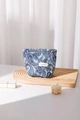 Detail view of blue paisley cosmetic bag with jacquard fabric and silver flower zipper pull - Blue Small