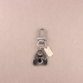 Silver alloy planchette keychain with moon and sun engravings on a beige background - Letter Planchette - Silver Text