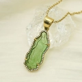 Detail of 18k gold plated Virgin Mary pendant with green glass and sparkling crystals - Transparent Green