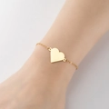 Minimalist golden heart charm bracelet on model's wrist with polished finish - 351-Solid Heart