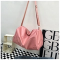 Detailed view of pink waterproof nylon travel bag with adjustable strap and metal buckle - Pink (No Charm)