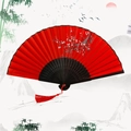 Traditional Chinese folding fan featuring red fabric with white plum blossoms and red tassel - Smile White Plum - Red Plum