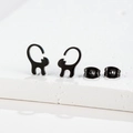 Detailed view of black minimalist cat studs with butterfly backs on a white stone base - Cat 1 / Black
