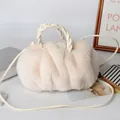 White faux rabbit fur pumpkin handbag with braided leather handle and plush texture - White