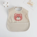 Waterproof baby bib with pink bear print and large food catcher pocket in beige - Pu Bib (double-layer Pocket) - Peach Heart Sloth Bear / One Size