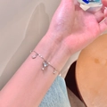 Silver charm bracelet with stars, moon, heart scepter and pearls on woman's wrist - Exquisite Star Moon Pearl Bracelet / Silver