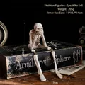 Skeleton yoga figurine in 'Speak No Evil' pose on vintage books for Halloween decor - Skull Figurine - Speak No Evil