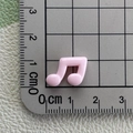 Pink resin musical note charm detail showing size measurement of 1.5cm on scale - Pink