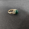 Detailed macro view of handmade gold wire-wrapped ring with a green gemstone bead - Adjustable Open / Green Agate