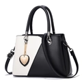 Minimalist black and white patchwork leather handbag with silver heart pendant - Black and White